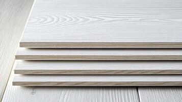 A close-up showcasing the layers of wooden planks with a white finish, revealing intricate grain patterns. Simple and elegant texture. photo