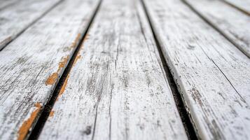 Rustic painted white wooden surface showing signs of wear and age, close-up texture with weathered paint and visible grain. photo