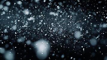 A flurry of snow falls gently against a dark backdrop, creating a serene and wintery scene filled with a sense of peaceful stillness. photo