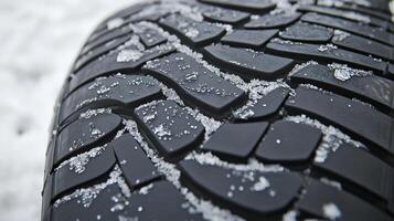 Close-up of tire tread pattern showing intricate design in snowy conditions, symbolizing safe winter driving with traction in cold weather. photo