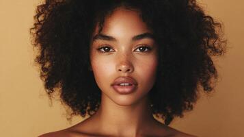 Close-up of a beautiful woman with curly dark hair, freckles, and a warm complexion against a neutral background. photo