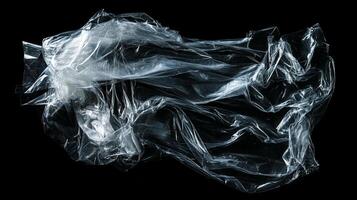 Translucent plastic sheet abstract. Thin, crumpled material illuminated. Recyclable, flexible, clear. Clean studio shot on black. photo