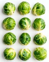 Freshly harvested Brussels sprouts arranged in a neat pattern on a clean white surface photo
