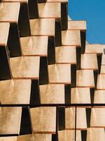 Sunlight illuminating beige concrete balconies creating a geometric pattern. Strong sunlight illuminating beige concrete balconies, creating a mesmerizing geometric pattern of light and shadow photo