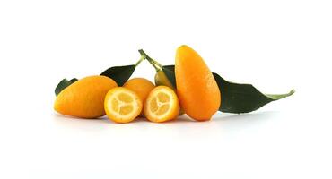 Fresh kumquats with leaves showing the inside on white background photo