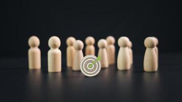 Team target concept of business and personnel in a company. Wooden dolls standing around Dart board and arrows for creating and targeting business objectives, Marketing solutions, Targets for business photo