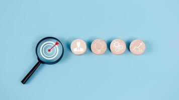 Business goals and objective concepts, Goal and target, Success and business target concept, Project management, Company strategy, Magnifying glass focus to target objective with icon action plan. photo