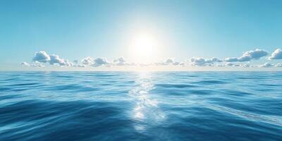 Sunrise over calm ocean waters with gentle waves and a clear blue sky photo