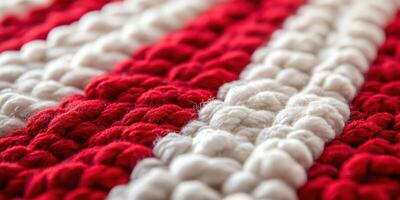 Detailed close-up of a handmade textile featuring red and white patterns with intricate woven textures photo