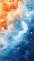 Colorful swirling vapor in vibrant orange and blue tones creating a dramatic abstract effect photo