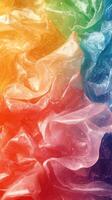 Brightly colored crumpled plastic material creates an abstract pattern in vivid rainbow hues photo