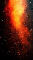 Vibrant display of orange and gold particles swirling against a dark background creates a captivating visual experience photo