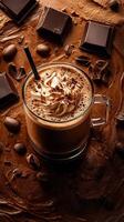 Creamy chocolate beverage topped with whipped cream and chocolate shavings on a bed of cocoa and coffee beans photo