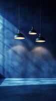 Three pendant lights casting soft illumination on a blue textured wall in a modern space photo