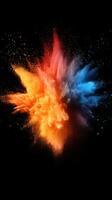 Colorful explosion of orange and blue powder bursts against a black background creating dynamic visual impact photo