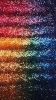 Vibrant glitter gradient transitions across a dark background creates a mesmerizing pattern photo