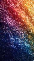 Sparkling glitter backdrop showcasing vibrant colors in a mesmerizing gradient of gold, red, blue, and purple photo
