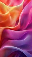 Vibrant silk fabric in shades of orange, pink, and purple drapes gracefully with flowing textures photo