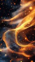Swirling golden particles create a mesmerizing abstract design with hints of blue in a dark background photo