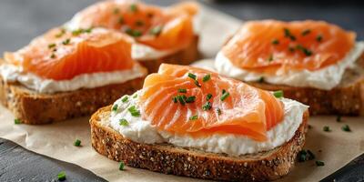 Delicious open-faced sandwiches with smoked salmon and cream cheese on whole grain bread photo