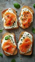 Fresh salmon and cheese toast served on whole grain bread, topped with herbs photo