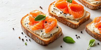 Delicious slices of bread topped with creamy cheese and smoked salmon garnished with fresh herbs photo
