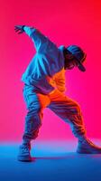 Stylish dancer performing dynamic moves against a vibrant pink and blue backdrop in urban attire photo