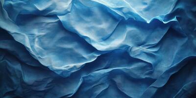 Blue fabric draping across a surface showing texture and depth in a soft lighting environment photo