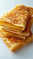 Fluffy golden pancakes stacked neatly on a white background, showcasing delicious texture and warmth, perfect for breakfast or brunch photo