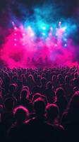 Crowded concert with vibrant lights and fog creating an energetic atmosphere in the evening photo