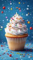 Colorful cupcake with cream frosting and sprinkles on a blue background creating a cheerful dessert atmosphere photo