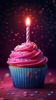 Colorful cupcake with pink frosting and a candle lit, perfect for celebrating a special occasion photo