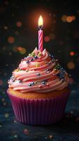 Bright and colorful cupcake with a candle glowing on top, perfect for celebrations and birthdays at night photo