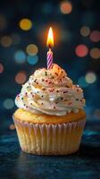 Colorful cupcake with candle glowing in a festive atmosphere during a celebration at night photo