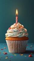 Festively decorated cupcake with a single candle on top surrounded by colorful sprinkles on a teal background photo