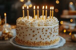 Elegant white cake with golden candles and decorations on festive background. photo