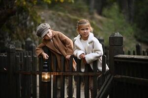 a boy and girl with fading light in a hands stand on man old wooden bridge at dusk, wrapped in the glow of a vintage lantern photo