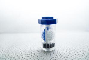 close-up of a container for cleaning and storing contact lenses for the eyes, used at home. For soft and hard lenses. in the container there is an active cleaning process, bubbles are released. photo