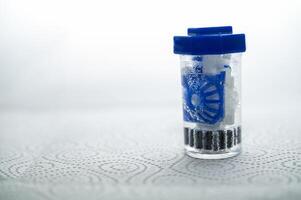 close-up of a container for cleaning and storing contact lenses for the eyes, used at home. For soft and hard lenses. The container is in the active cleaning process, the container is closed photo