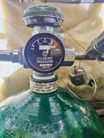 Close-up of a high-pressure gas cylinder with a regulator and gauge reading. High quality photo