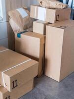 Stacked cardboard boxes for delivery and packaging storage indoors photo