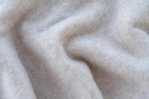 Close-up of soft white mohair fabric with delicate fibers and fluffy texture photo