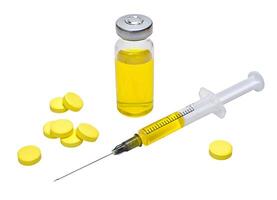 Yellow vaccine in vial with syringe and yellow tablets on white background photo