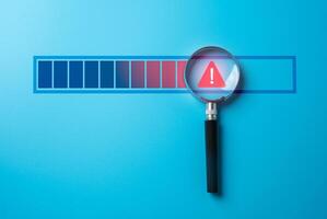 Magnifying glass with warning sign on progress bar. Find problem stop or malfunction. Detecting issues, troubleshooting errors. Identifying malfunctions, stopping critical problems in processes. photo