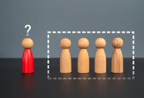 There is no place for the red man in the group. Social isolation. Exclusion, discrimination. photo