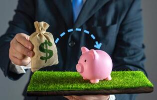 A businessman puts money into savings. Financial security and smart money management. Funds into a savings account, building wealth, securing the future, and practicing responsible financial planning. photo
