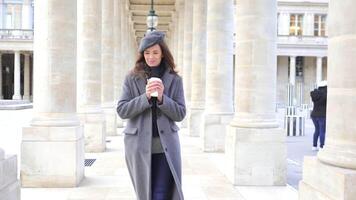 Girl in Paris Strolling with Coffee Between Columns at Royal Palace video