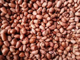 pile of peanuts or Arachis hypogaea L. for sale in the market photo