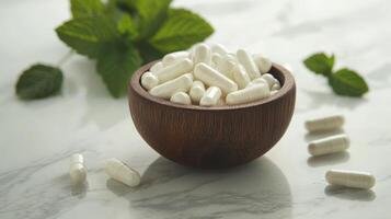 Natural Supplements in Wooden Bowl with Mint Leaves photo