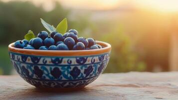 Freshly picked blueberries in a beautiful patterned bowl photo